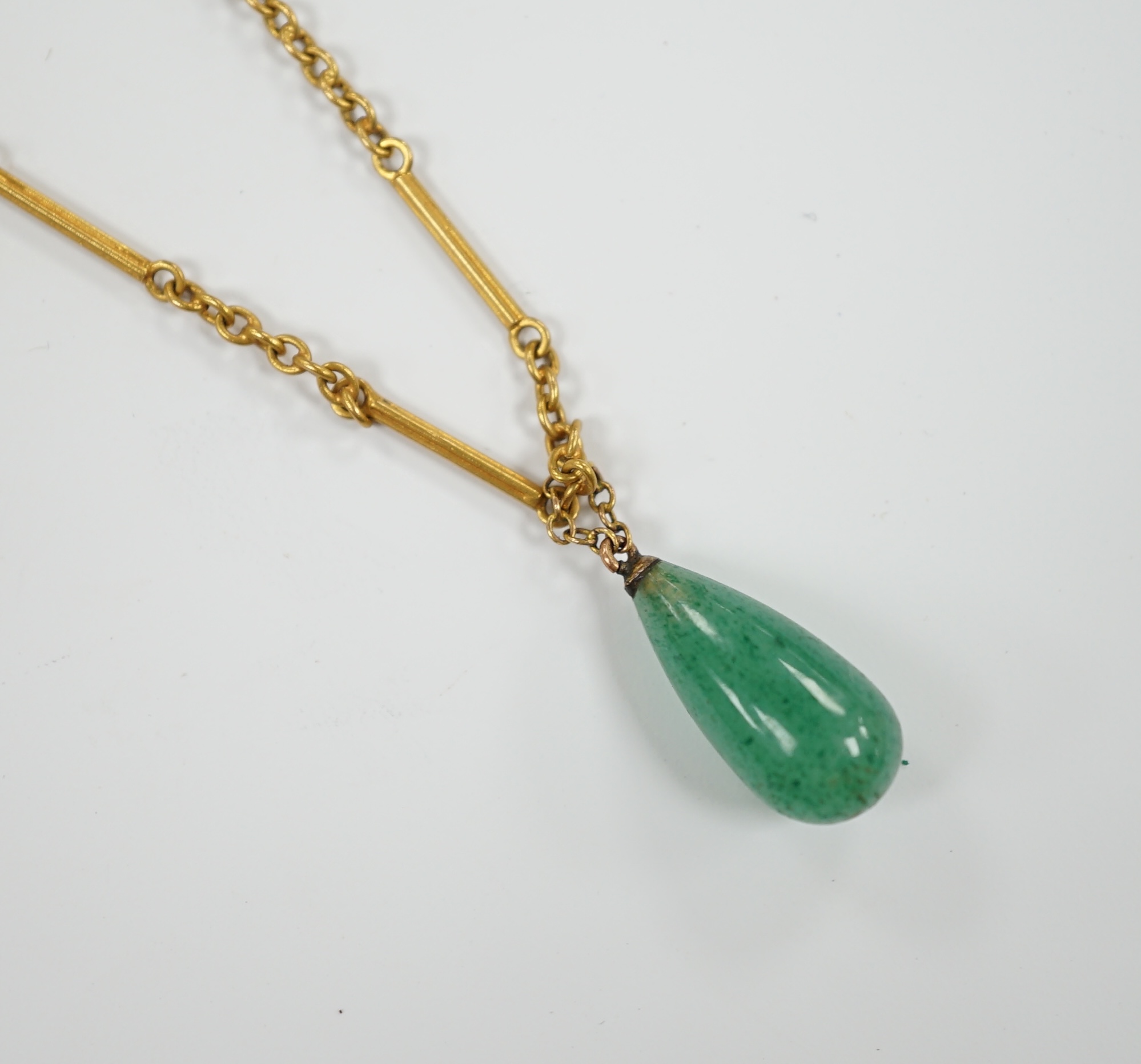 An early 20th century 15ct and single stone pear shaped simulated jade set pendant necklace, overall 46cm, gross weight 6 grams.